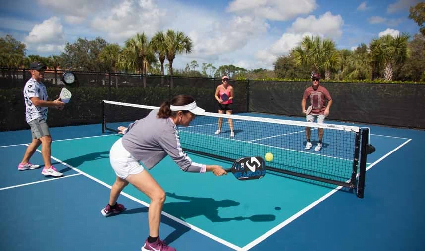 The pickleball net height is 36" at the sideline and 34" at the center. Pickleball is most often played as doubles with four players, two on each team (though singles is possible as well). Each player stands to the right and left of the centerline. You can hit two types of shots: